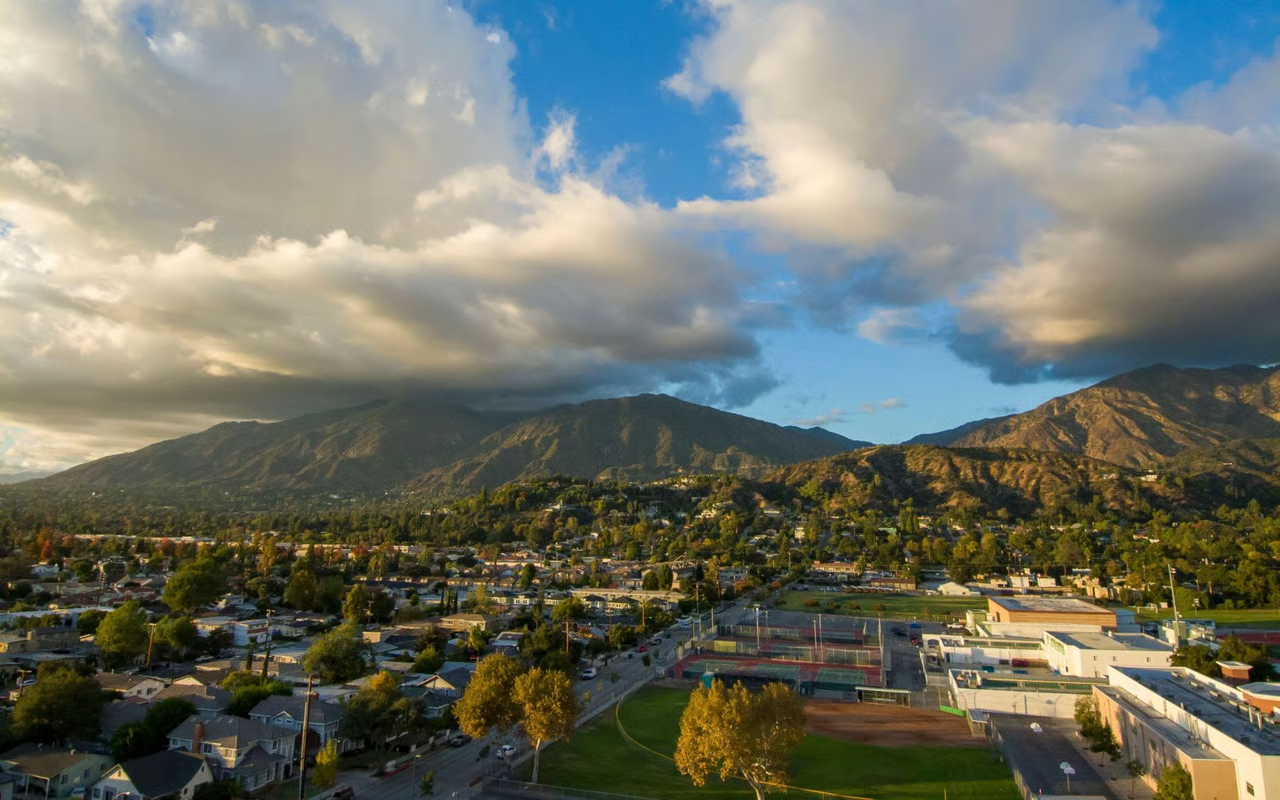 Aerial view of foothill neighborhoods beneath the San Gabriel Mountains